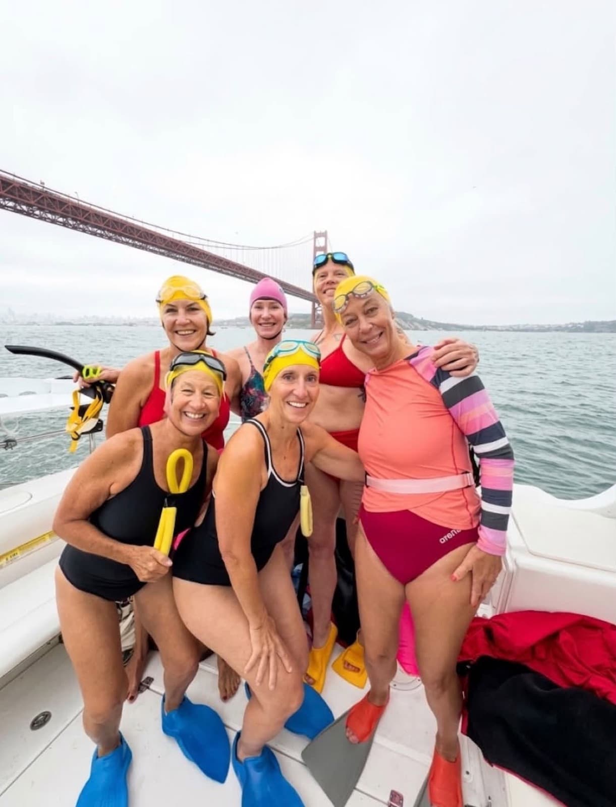 Swimmers aboard Miss Molly with the Golden Gate Bridge behind them